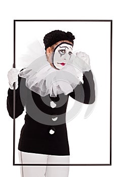Female clown in a frame is crying