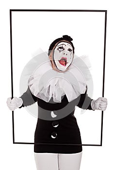 A female clown in a frame is crying