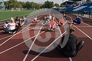 Female coach and group of children conducts a training session