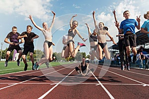 Female coach and group of jumping children