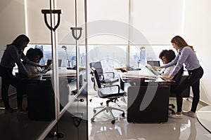 Female Colleagues Architect Using Tablet PC In Office