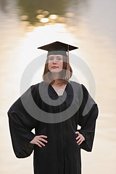 Female college graduate with hands on hips