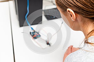 Female College Student Building Machine In Science Robotics Or Engineering Class.Stem education.Closeup