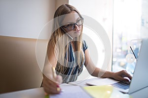 Female college student having online learning via netbook via netbook