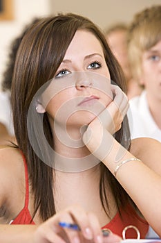 Female college student listening to a lecture