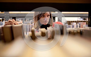 female college student in a llibrary