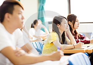 female college student sitting with classmates photo