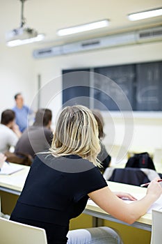 Female college student sitting in a classroom