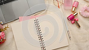 Female college student study table with empty pages of school spiral notebook