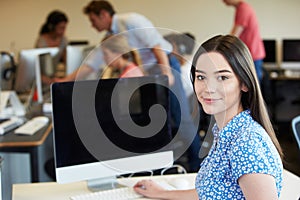 Female College Student Using Computer In Classroom