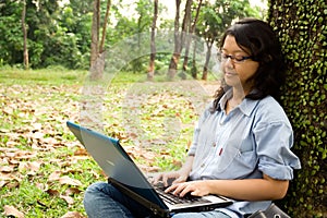 Female college student working on a laptop
