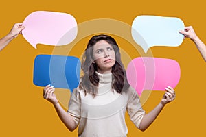 Female with colorful cardboard tablets in her hands staring upwards