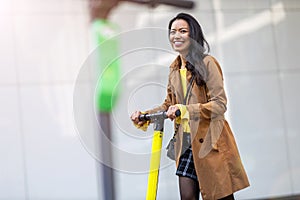 Female commuter riding electric push scooter