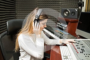 Female composer listening her new track