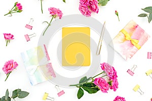 Female composition with notebook, eucalyptus, gift and roses on white background