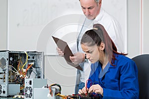 female computer engineer repairing computer