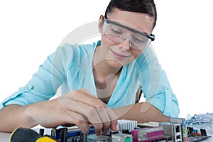 Female computer engineer repairing computer motherboard