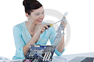 Female computer engineer repairing computer motherboard