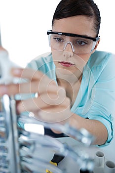 Female computer engineer repairing computer motherboard