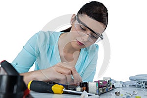 Female computer engineer repairing computer motherboard