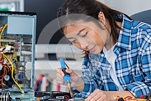 Female computer technician using soldering iron