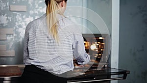 Female confectioner in her own modern litchen. Gets ready tartlets on a tray from the oven using gloves