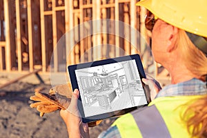 Female Construction Worker Reviewing Kitchen Drawing on Computer