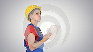 Female construction engineer looking at tablet and checking obje