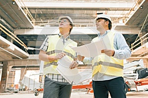 Female construction inspector examining construction site. Building, development, teamwork and people concept