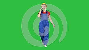 Female construction woman making a call on a Green Screen, Chroma Key.