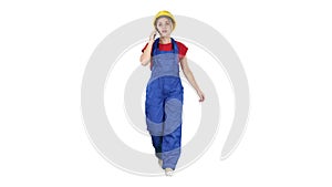 Female construction woman making a call on white background.