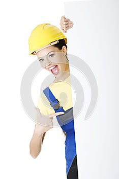 Female construction worker with blank board