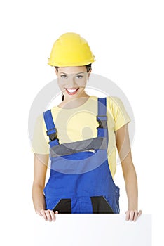 Female construction worker with blank board
