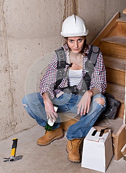 Female construction worker drinking beer