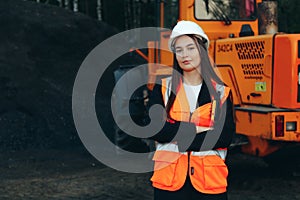 Female Construction Worker Engineer with a Front Loader Machine on Industrial area