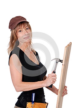 Female construction worker hammering