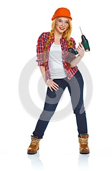 Female construction worker in a helmet with a perforator