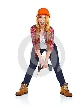 Female construction worker in a helmet with a perforator