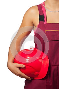 Female construction worker holding red hard hat