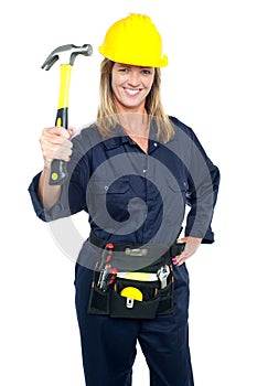 Female construction worker holding up hammer