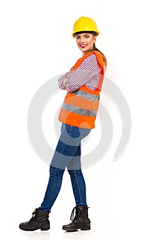 Female Construction Worker Leans On A Wall