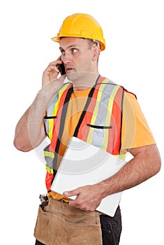 Female construction worker looking at plans on a new home constr