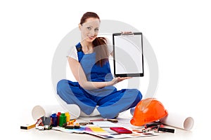 Female construction worker shows blank clipboard.