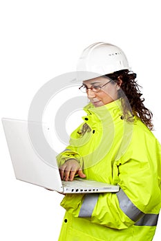 Female construction worker write in a laptop