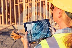 Female Construction Workers Reviewing Building on Computer Pad