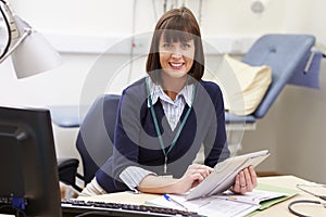 Female Consultant Using Digital Tablet At Desk In Office