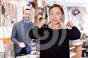 Female consumer trying chainlet with pendants