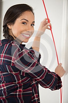 female contractor installing red beading photo