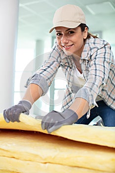 female contractor installing rockwool insulation