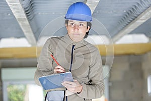 female contractor writing on clipboard